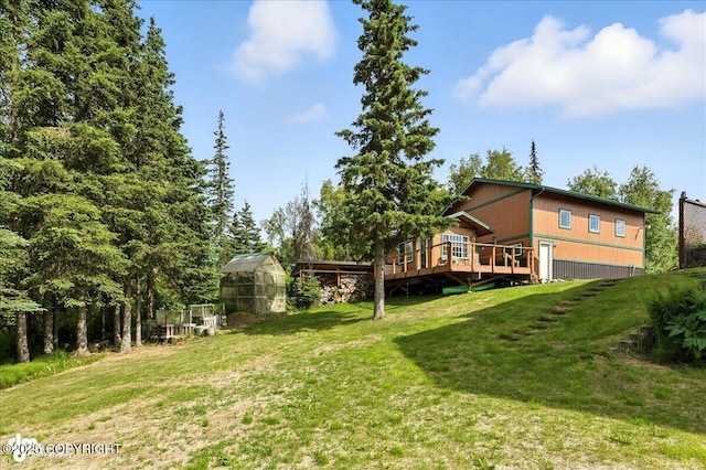 48350 Lakeside Ave, Soldotna, AK 99669 - view of grassy yard featuring an exterior structure, a deck, and an outbuilding