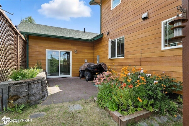 48350 Lakeside Ave, Soldotna, AK 99669 - back of property featuring a patio and a shingled roof