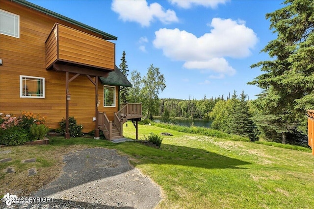 48350 Lakeside Ave, Soldotna, AK 99669 - view of green lawn with stairs and a deck with water view
