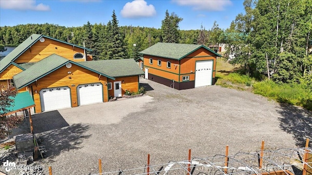48350 Lakeside Ave, Soldotna, AK 99669 - view of front facade featuring a detached garage and a view of trees