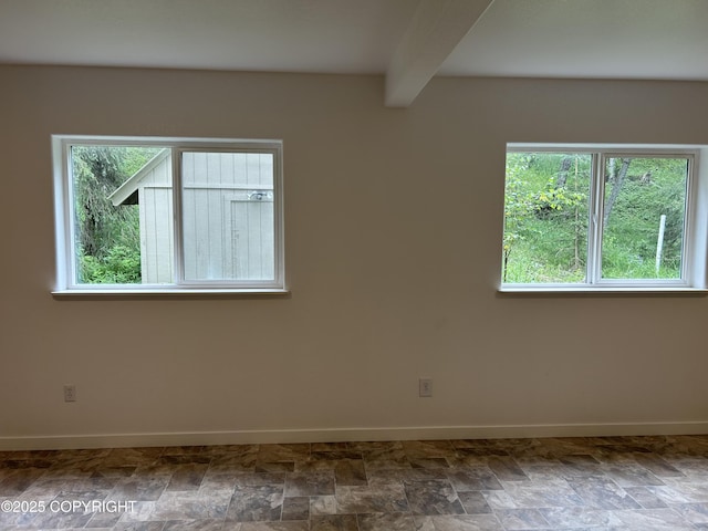 172 Linda Ln, Soldotna, AK 99669 - unfurnished room featuring beam ceiling and stone finish floors