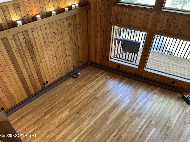 172 Linda Ln, Soldotna, AK 99669 - unfurnished room with wood finished floors, a baseboard radiator, and wooden walls
