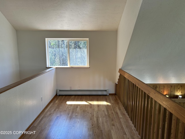 172 Linda Ln, Soldotna, AK 99669 - spare room featuring a baseboard radiator and wood finished floors