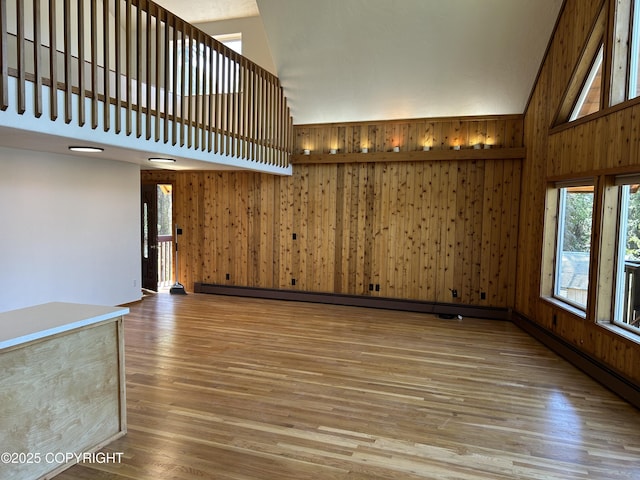 172 Linda Ln, Soldotna, AK 99669 - unfurnished living room with high vaulted ceiling, wood finished floors, and wooden walls