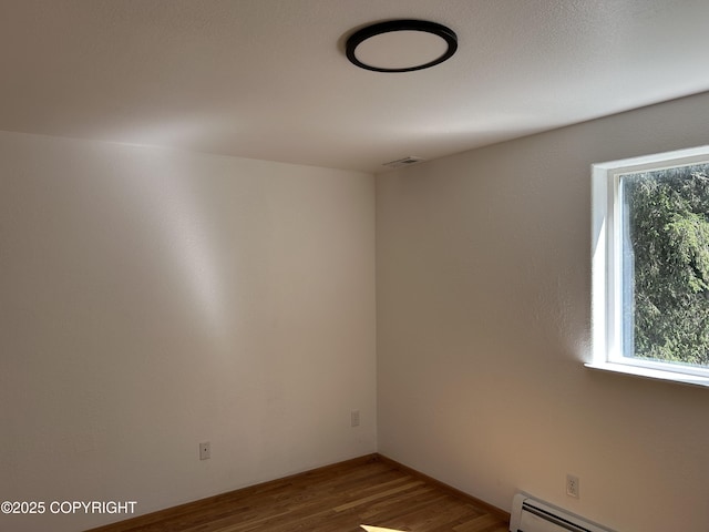 172 Linda Ln, Soldotna, AK 99669 - unfurnished room with baseboard heating and wood finished floors