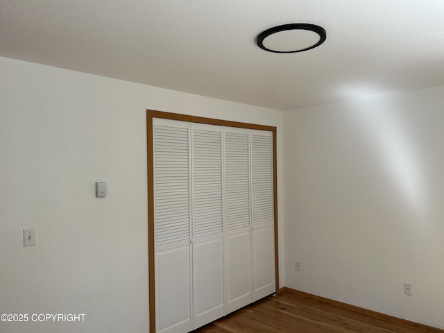 172 Linda Ln, Soldotna, AK 99669 - unfurnished bedroom with dark wood finished floors and a closet