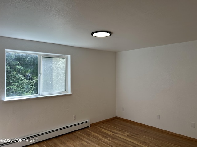 172 Linda Ln, Soldotna, AK 99669 - unfurnished room with baseboard heating and wood finished floors