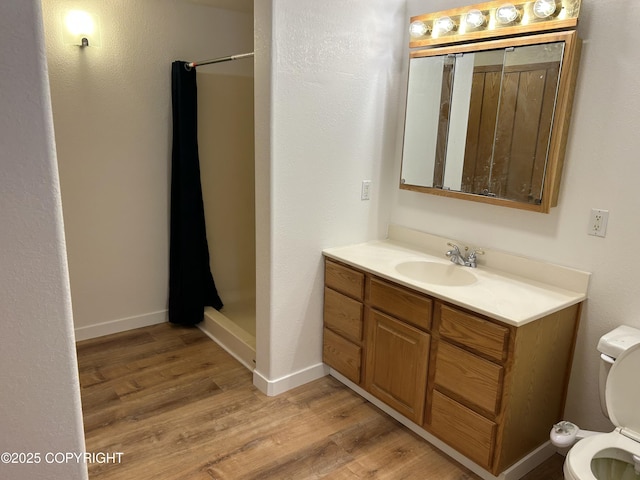 172 Linda Ln, Soldotna, AK 99669 - bathroom featuring a stall shower, vanity, and wood finished floors