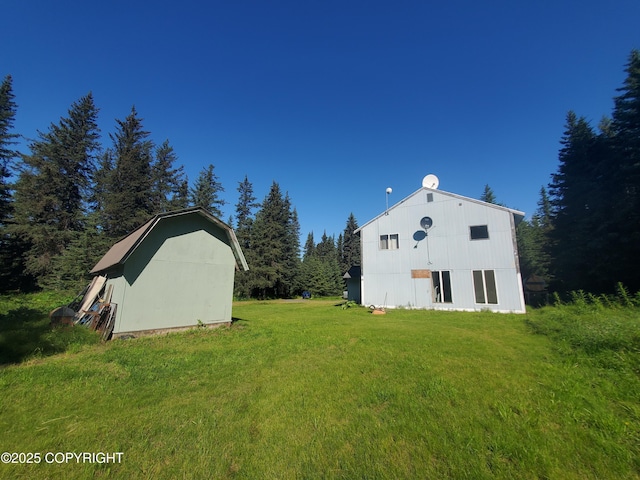 35196 Nordic Ct, Anchor Point, AK 99556 - view of home's exterior featuring an outdoor structure, a lawn, and a gambrel roof