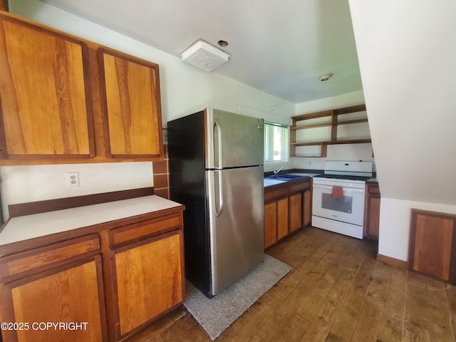 35196 Nordic Ct, Anchor Point, AK 99556 - kitchen with freestanding refrigerator, white range with gas cooktop, open shelves, and brown cabinetry