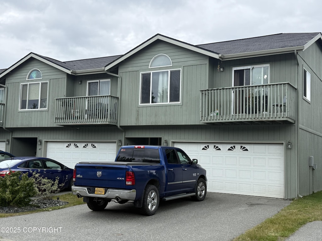 401 S Wasilla St # 48, Wasilla, AK 99654 - view of front facade with a garage, a balcony, and driveway
