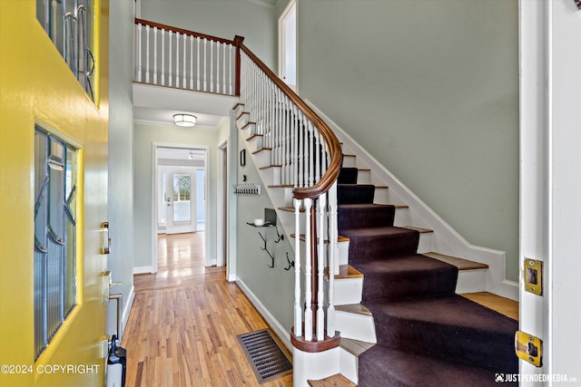 1334 K St, Anchorage, AK 99501 - stairs featuring wood finished floors, crown molding, and a towering ceiling