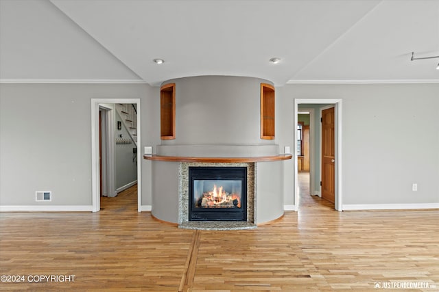 1334 K St, Anchorage, AK 99501 - unfurnished living room featuring a glass covered fireplace, light wood-type flooring, lofted ceiling, recessed lighting, and ornamental molding