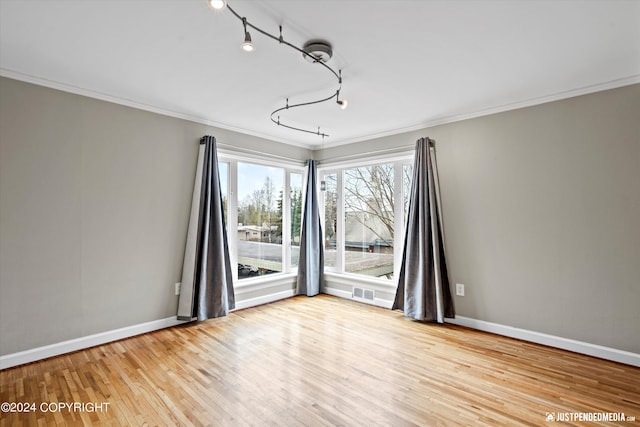 1334 K St, Anchorage, AK 99501 - empty room featuring ornamental molding and hardwood / wood-style flooring
