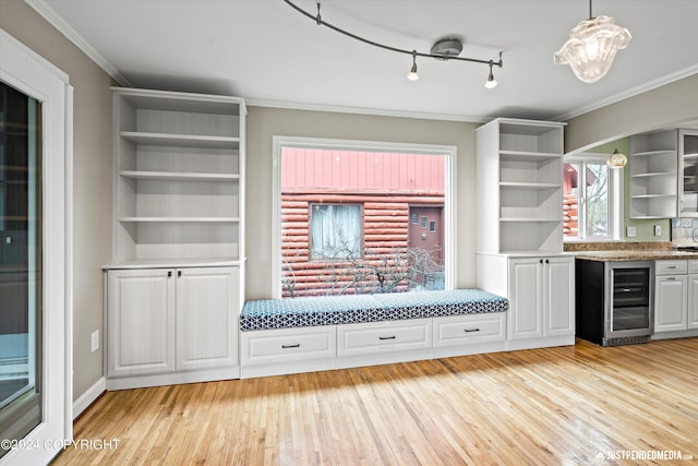 1334 K St, Anchorage, AK 99501 - mudroom featuring wine cooler, light wood-type flooring, ornamental molding, and bar area