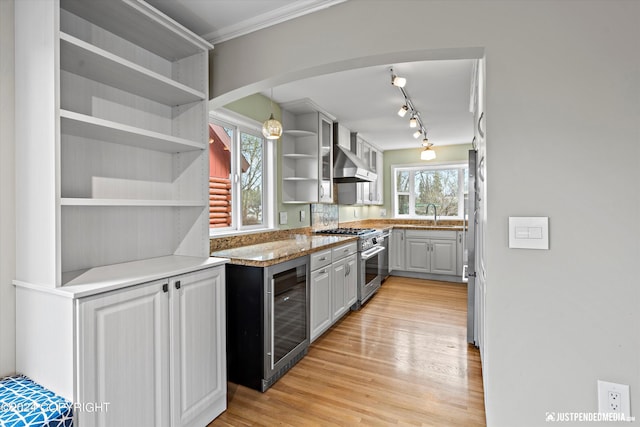 1334 K St, Anchorage, AK 99501 - kitchen featuring stainless steel range, wine cooler, open shelves, light wood-style flooring, and track lighting