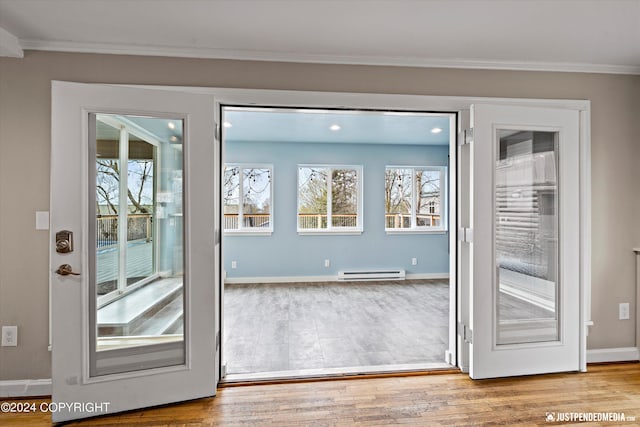 1334 K St, Anchorage, AK 99501 - doorway to outside with baseboard heating, crown molding, wood finished floors, and recessed lighting