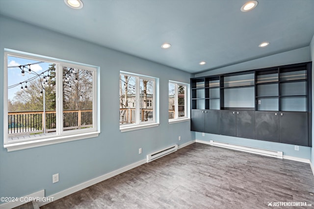 1334 K St, Anchorage, AK 99501 - unfurnished room featuring a baseboard heating unit, plenty of natural light, recessed lighting, lofted ceiling, and wood finished floors