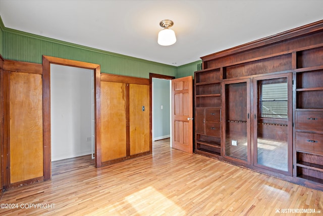 1334 K St, Anchorage, AK 99501 - unfurnished bedroom with wood finished floors and crown molding