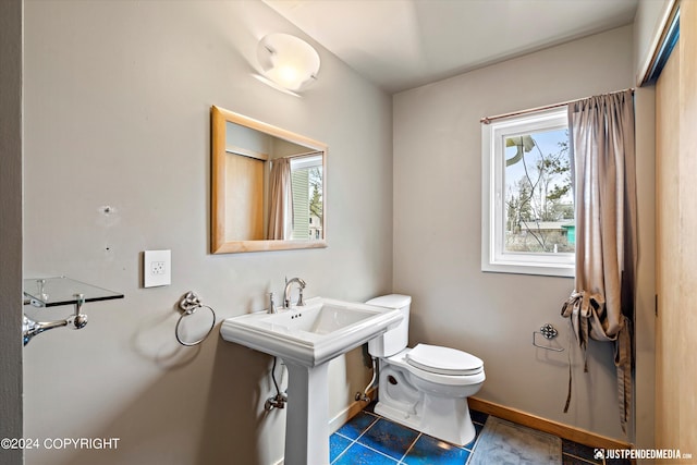 1334 K St, Anchorage, AK 99501 - half bathroom featuring healthy amount of natural light and tile patterned flooring