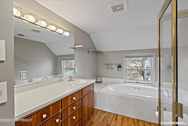 1334 K St, Anchorage, AK 99501 - bathroom featuring vanity, a garden tub, lofted ceiling, wood finished floors, and a shower with shower door