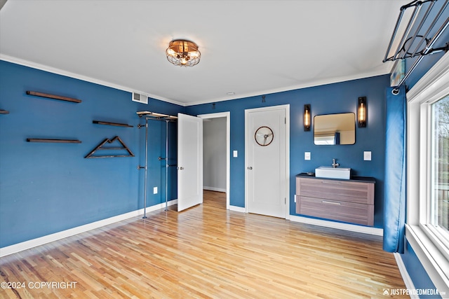 1334 K St, Anchorage, AK 99501 - unfurnished bedroom featuring light wood finished floors and ornamental molding