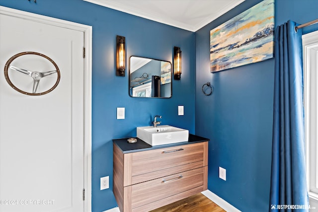 1334 K St, Anchorage, AK 99501 - bathroom with vanity, crown molding, and wood finished floors