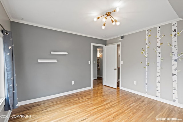 1334 K St, Anchorage, AK 99501 - unfurnished bedroom with wood finished floors, crown molding, and a chandelier