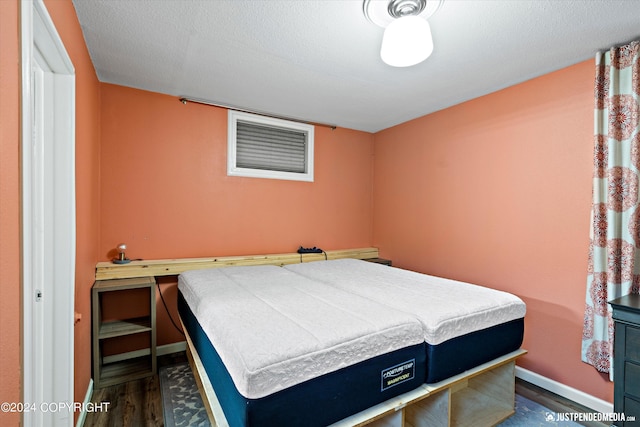 1334 K St, Anchorage, AK 99501 - bedroom featuring dark wood finished floors and baseboards