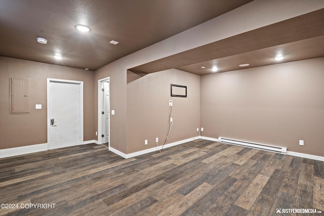 1334 K St, Anchorage, AK 99501 - below grade area featuring a baseboard radiator, dark wood-style flooring, electric panel, and recessed lighting