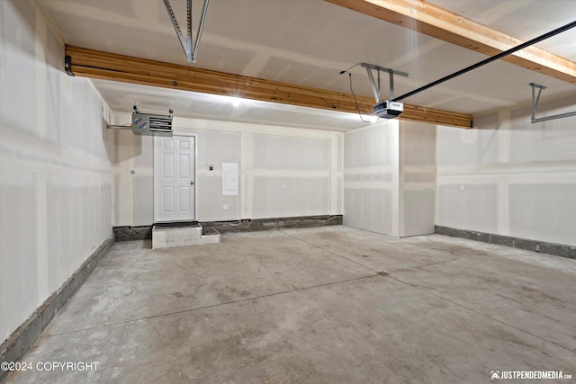 1334 K St, Anchorage, AK 99501 - garage featuring a garage door opener and baseboards