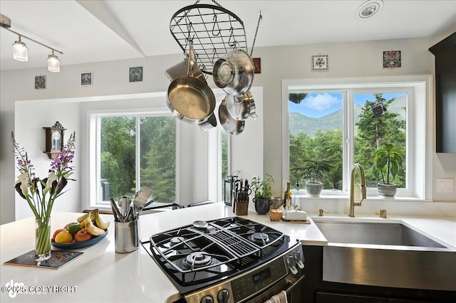 21009 River Park Dr, Eagle River, AK 99577 - kitchen with range, healthy amount of natural light, light countertops, and track lighting