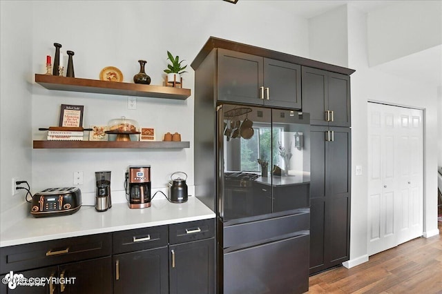 21009 River Park Dr, Eagle River, AK 99577 - kitchen featuring stainless steel refrigerator, open shelves, wood finished floors, and light countertops
