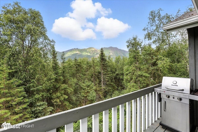 21009 River Park Dr, Eagle River, AK 99577 - balcony featuring a grill, a mountain view, and a view of trees