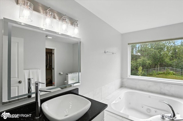 21009 River Park Dr, Eagle River, AK 99577 - bathroom featuring a tub with jets, lofted ceiling, and vanity