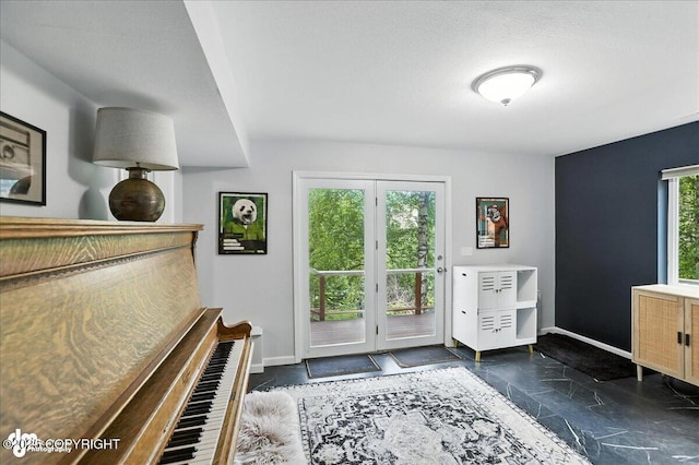 21009 River Park Dr, Eagle River, AK 99577 - entryway featuring baseboards and dark stone finish floors