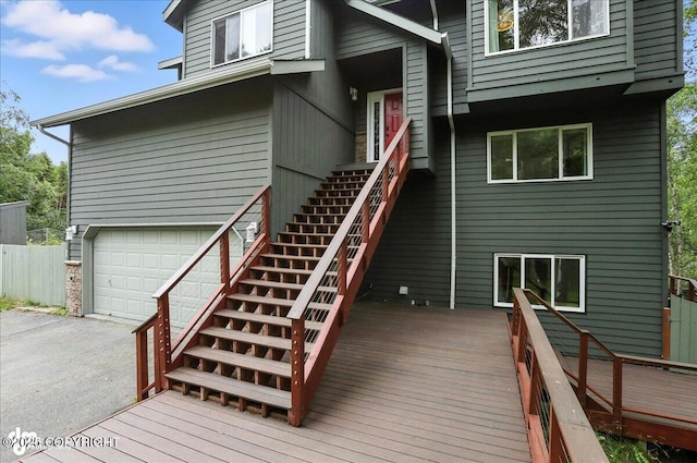 21009 River Park Dr, Eagle River, AK 99577 - wooden terrace featuring stairway, an attached garage, and asphalt driveway