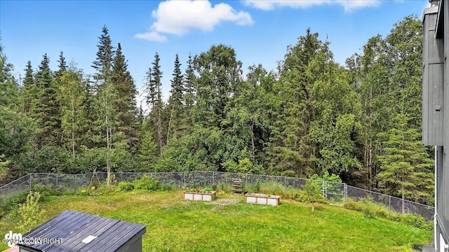 21009 River Park Dr, Eagle River, AK 99577 - view of yard featuring a vegetable garden and a forest view