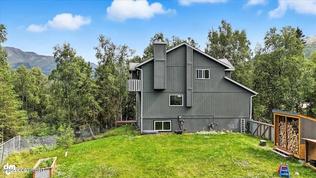 21009 River Park Dr, Eagle River, AK 99577 - back of property featuring a chimney and a mountain view