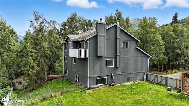 21009 River Park Dr, Eagle River, AK 99577 - view of home's exterior with a chimney, a balcony, and a wooded view