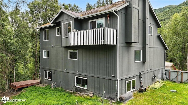 21009 River Park Dr, Eagle River, AK 99577 - view of side of property featuring a balcony and a lawn