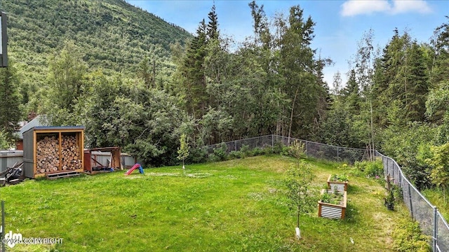 21009 River Park Dr, Eagle River, AK 99577 - view of yard with a view of trees, a garden, and a mountain view