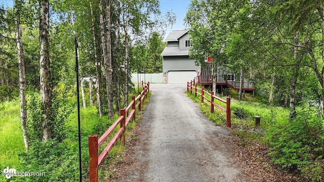 21009 River Park Dr, Eagle River, AK 99577 - view of front of property featuring driveway, a garage, and a wooden deck