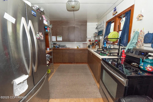318 W 10th Ave, Anchorage, AK 99501 - kitchen featuring appliances with stainless steel finishes, light countertops, and brown cabinetry