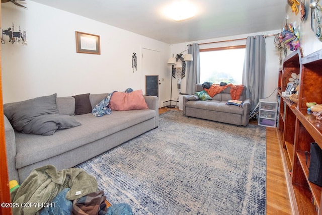 318 W 10th Ave, Anchorage, AK 99501 - living room featuring wood finished floors and baseboard heating