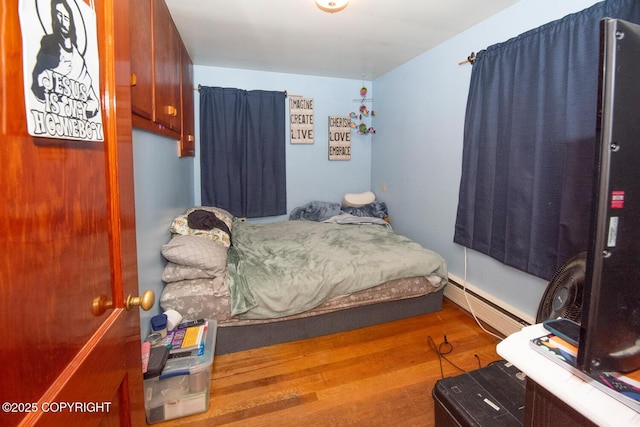 318 W 10th Ave, Anchorage, AK 99501 - bedroom with wood finished floors and baseboard heating