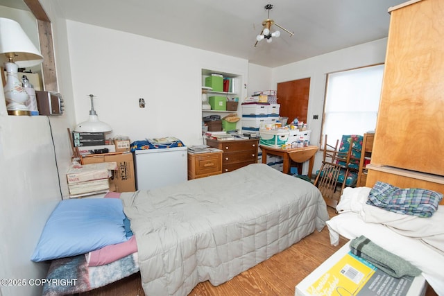 318 W 10th Ave, Anchorage, AK 99501 - bedroom featuring wood finished floors and a chandelier