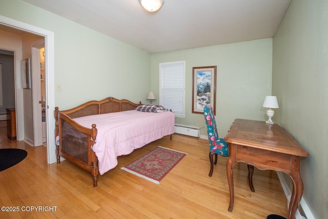 326 W 10th Ave, Anchorage, AK 99501 - bedroom with wood finished floors and a baseboard heating unit