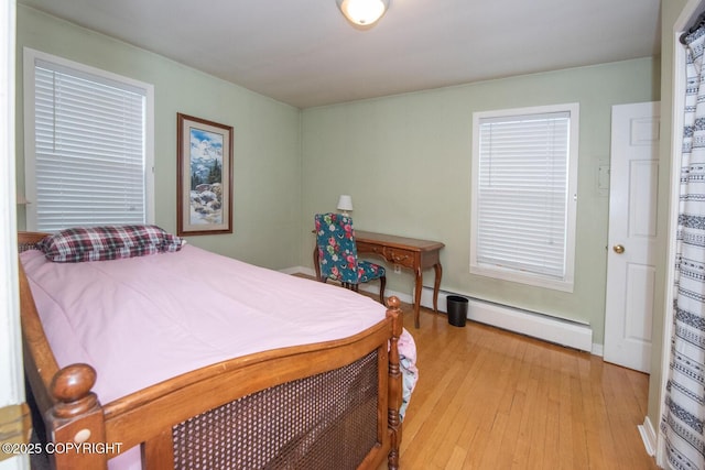 326 W 10th Ave, Anchorage, AK 99501 - bedroom featuring a baseboard heating unit and light wood finished floors