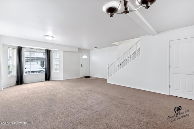 6507 Kara Sue Loop # 83, Anchorage, AK 99504 - unfurnished living room featuring carpet flooring, stairs, and a chandelier